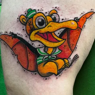 Tattoo von Tschiggy mit einem Dinosaurier im Bubblegum-Art-Stil